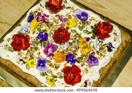 Homemade hummingbird cake with mixed flower toppings and hand carved rose bulb from strawberry / Flowery cake / Mixed edible flowers purchased