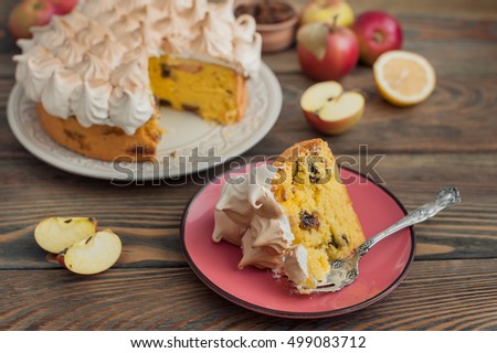 Apple cake with lemon curd and meringue on wooden background.