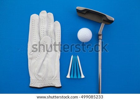 Different golf equipments on the blue desk - flat lay photography