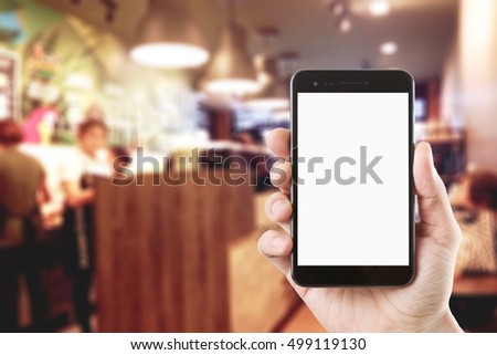 right hand using smartphone with blank screen on Abstract blur people in coffee shop, urban lifestyle concept, coffee shop,
