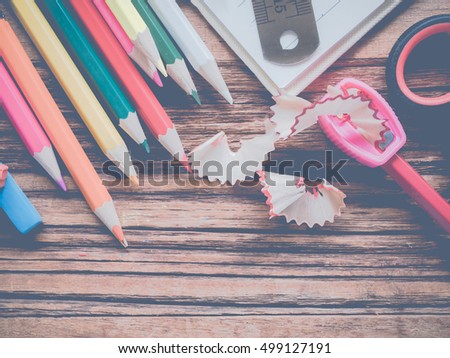 Close up school and office supplies on wood background.