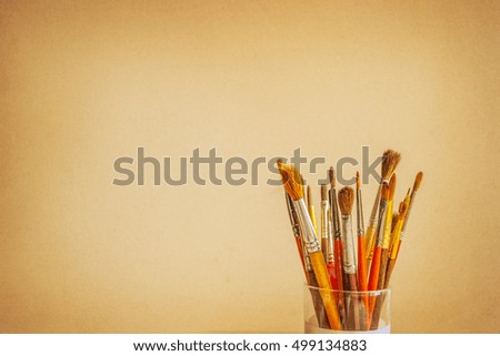 Photo of paint brushes in a glass