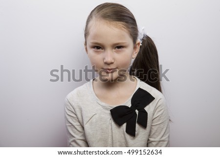 little girl making faces. acting, depiction of different emotions. the development of emotional intelligence. the child was up to something, squint into the face
