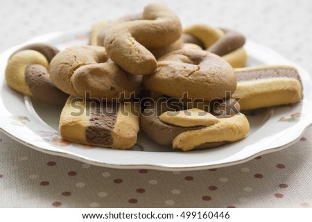 Greek dichromatic sweet cookies on white plate with children pictures