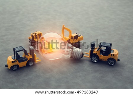 constrution car and glowing light bulb on grey leather background business creativity ideas concept