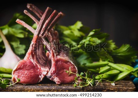 Rack of lamb , raw meat with bone on rustic kitchen table at wooden background, side view Royalty-Free Stock Photo #499214230
