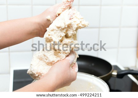 the finished dough for baking in hands of a cook