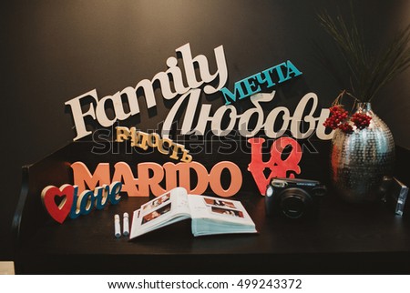Wooden letterings Family, dream, love stand on the table with wedding wishbook