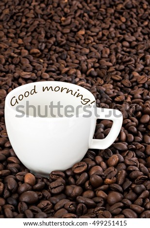 cup with the inscription on the background of coffee beans.