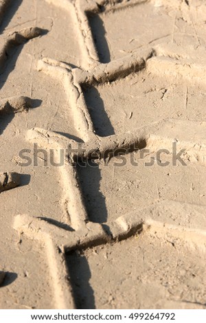 Tire tracks in the wet sand of a truck or tractor