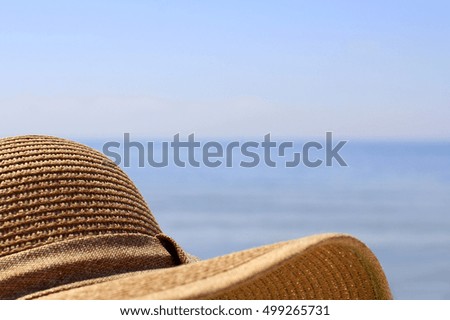 Hat lying on the beach. Beautiful seascape background. Horizontal image. Summer background