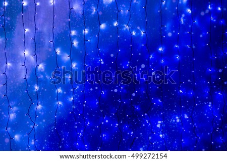 Christmas lights frame on dark blue background with copy space