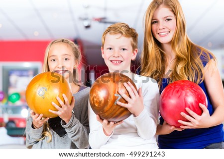 Children Friends playing together at bowling center