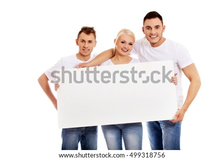 Group of happy friends holding empty banner
