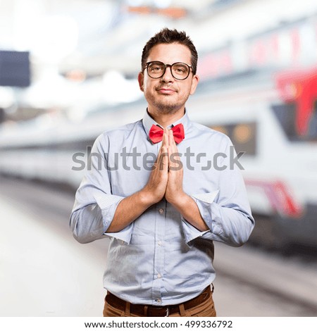 Man wearing a red bow tie. Praying.