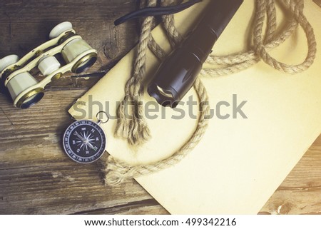 Compass rope and other items on the wooden background