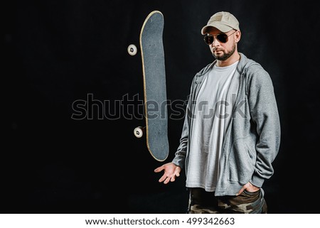 man with skateboard over hand on a black background
