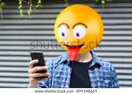 Emoji head man using a smartphone. Emoji concept Royalty-Free Stock Photo #499348669