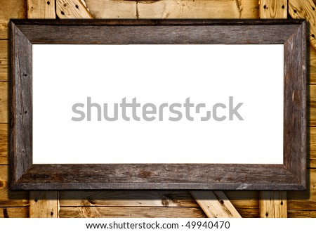 Rustic wood frame against barn door or wood panel background. Blank white template for your text or image.