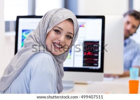 Young Arabic business woman wearing hijab,working in her startup office. Royalty-Free Stock Photo #499407511