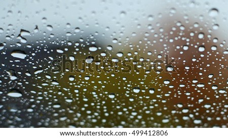Water drop on car window with blurry background
