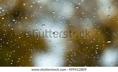 Water drop on car window with blurry background