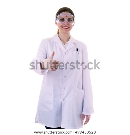 Smiling female assistant scientist in white coat and plastic protective glasses over white isolated background showing thunb up sign, healthcare, profession, science and concept