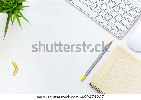 Top View of Modern Technology working Place on White Office Desk with Desktop Computer Keyboard and Mouse green Flower yellow Notepad Pen and other Stationery