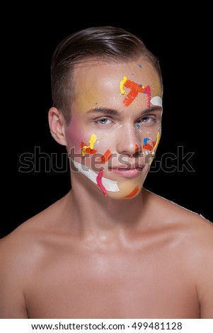 BEAUTIFUL MEN FACE. Fashion and Beauty, a stylish make-up on an experimental man's face. Portrait of a man with splashes of paint on PERSON     