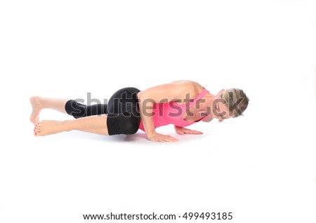 Single woman in tied back hair, pink top and black tights doing abdominal and thigh muscle exercises called spiderman