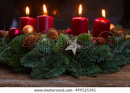 Evergreen fir tree advent garland with four burning candles on wooden background