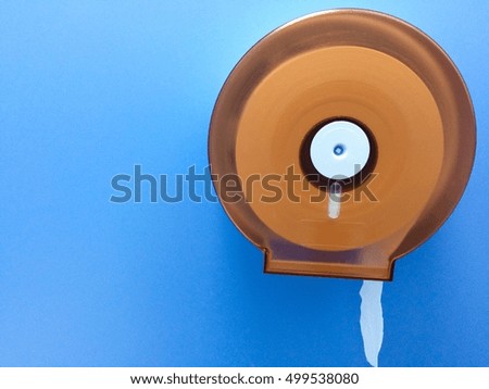 Paper roll in toilet and blue background