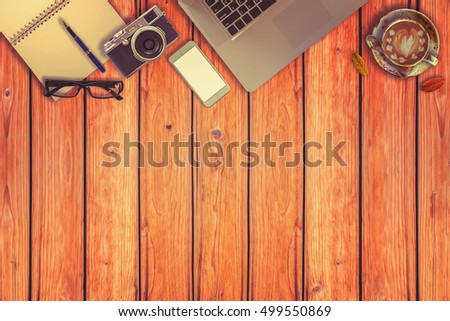 Workspace on rustic wood desk table of a hipster photographer.top view, vintage tone.