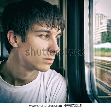 Toned Photo of Sad Teenager sit in the Train by the Window