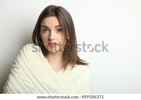Beautiful natural young girl, wearing knitted sweater and scarf. Winter fashion concept.