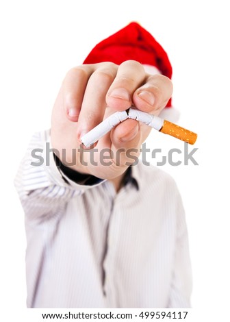 Person in Santa Hat with broken Cigarette in a Hand closeup on the White Background