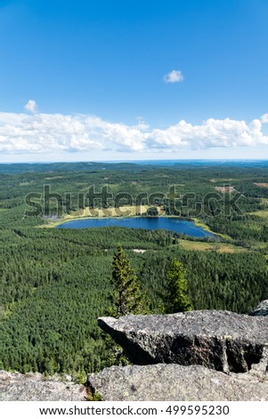 View of a lake in the form of a large footprint. Picture taken from the top of a high mountain in northern Sweden