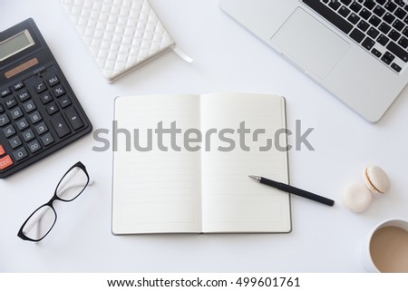 Top view of a working desk with open notebook, calculator, coffee. Close up, education concept photo, copyspace. High angle