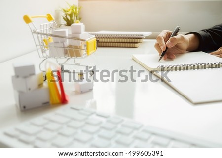 Internet online shopping concept with laptop and shopping-cart.Vintage tone retro filter effect,soft focus(selective focus)

