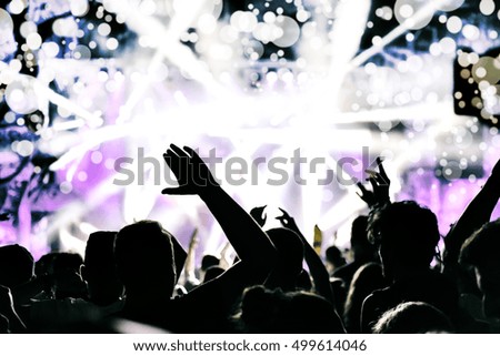 Crowd celebrating New Year, confetti and bokeh lights