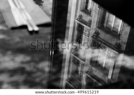 Reflection of typical Parisian building in marble table of Asian restaurant. Paris (France) Black and white.