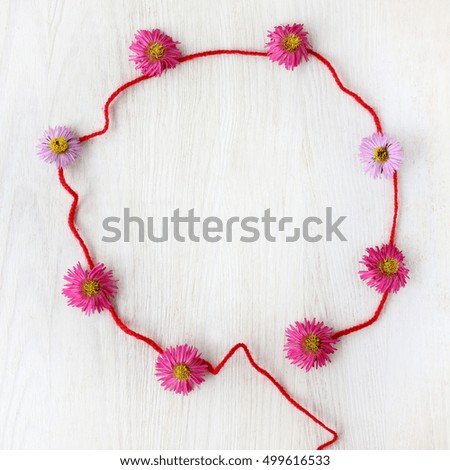 flat lay pattern frame with flowers on a light wooden background top view / air ball imagination