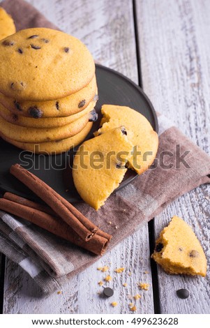 Homemade Pumpkin Spice Cookies with chocolate drops on Halloween,cinnamon sticks. Copy space