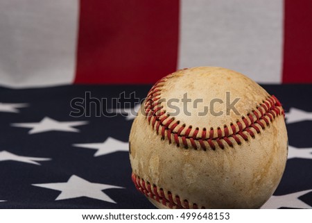 Baseball on top of an American flag. 
