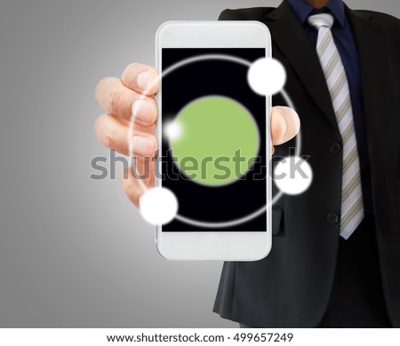 businessman showing his telephone with copyspace over gray background