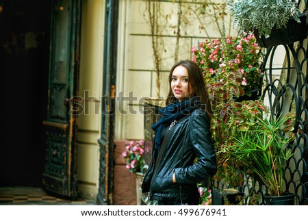 Outdoor portrait of young beautiful girl in town .
