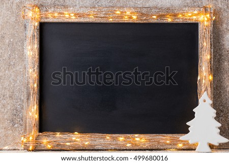 Christmas rustic background - vintage planked wood with lights and christmas decoration.