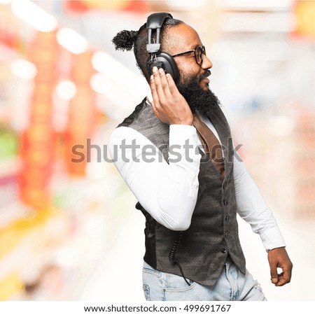 cool black man with headphones dancing
