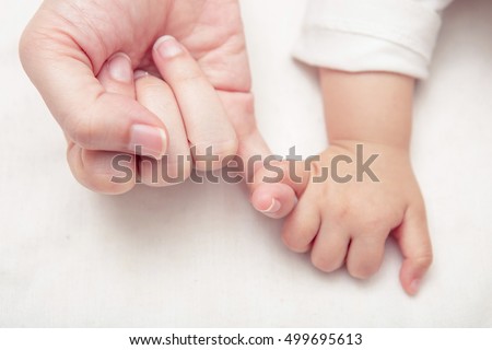 Mom and Baby Hands Promise friendship of generations, New family and baby protection from mom concept