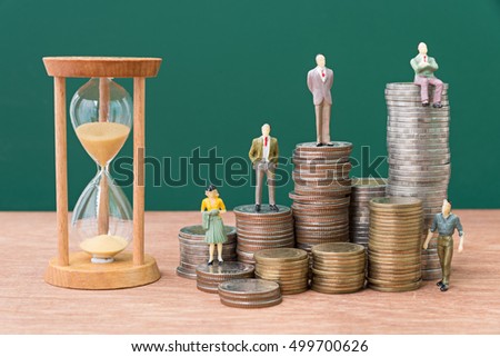 miniature people on stack of coins with sand glass green background